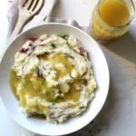 Get ready for Thanksgiving with Vegan Mashed Potatoes + Gravy - this is better than any turkey gravy I’ve ever had! | ThisSavoryVegan.com