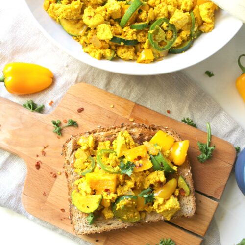 This Tofu Veggie Scramble is the perfect healthy breakfast - veggies are sautéed with protein packed tofu and the “miracle” seasoning turmeric | ThisSavoryVegan.com