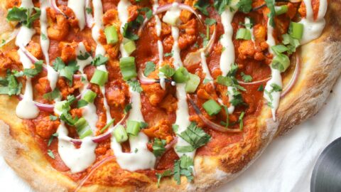 This Vegan Roasted Cauliflower Buffalo Pizza is the perfect balance of spiciness and creaminess with a nice crunch from the cauliflower | ThisSavoryVegan.com