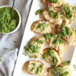 This White Bean Crostini with Pesto is savory and bright. Made with tons of fresh herbs this is sure to be the ultimate crowd pleaser | ThisSavoryVegan.com