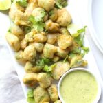 These Crispy Avocado Bites with Cilantro Jalapeño Vinaigrette are crunchy on the outside and creamy on the inside. Perfect vegan appetizer for your next party! | ThisSavoryVegan.com