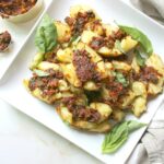 A tasty vegan appetizer or snack with a Mediterranean twist - Smashed Potatoes with Vegan Sun-Dried Tomato Pesto | ThisSavoryVegan.com