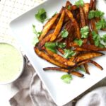 A quick and easy vegan snack - these Baked Fries with Vegan Cilantro Ranch combine seasoned fries with a creamy & savory dip | ThisSavoryVegan.com #vegan #vegansnack