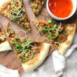 A vegan twist on a classic - this Roasted Cauliflower Vegan Thai Pizza combines spicy peanut sauce, zesty cauliflower, bean sprouts, carrots and jalapeños on a crispy crust | ThisSavoryVegan.com #vegan #veganpizza