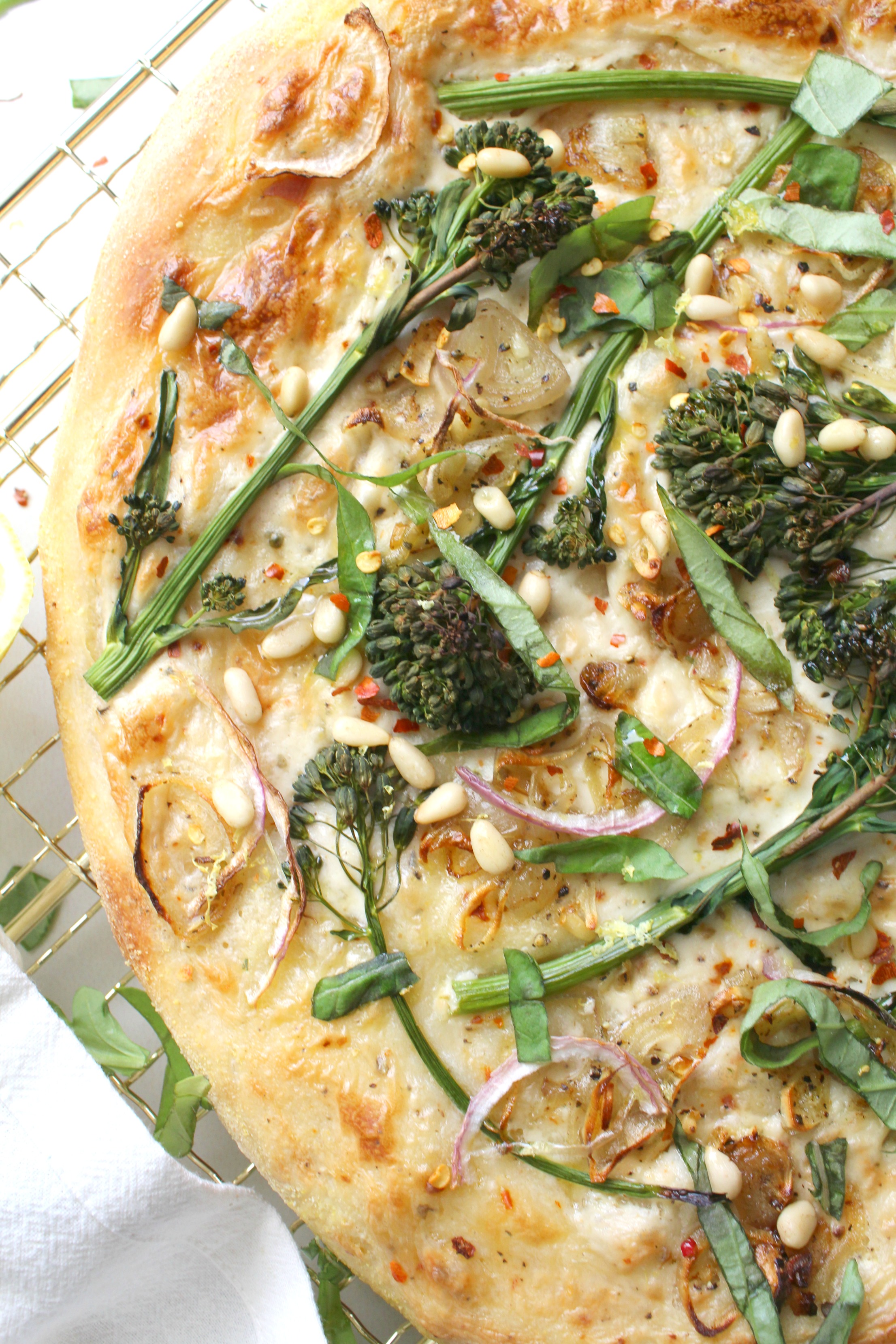 Restaurant-quality pizza with easy to find ingredients - this Broccolini & Shallot Vegan White Pizza is loaded with seasoned white sauce, crispy shallots and perfectly cooked broccolini | ThisSavoryVegan.com #vegan #veganpizza