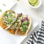 These Smashed Chickpea Tacos with Vegan Jalapeño Cream Sauce are the perfect blend of seasoned chickpeas, fresh slaw and a bit of spice! Taco Tuesday never looked so good | ThisSavoryVegan.com #tacotuesday #vegan