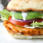 Dripping in flavor, crunch and spice, this is the Ultimate Vegan Buffalo Cauliflower Sandwich! Instructions for both baked and fried versions included | ThisSavoryVegan.com #vegansandwiches #buffalocauliflower #veganrecipes