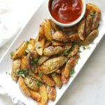 A quick snack that has all of the best flavors - these Smoky Potato Wedges with Sriracha Ketchup are simple, savory and a side dish everyone will love | ThisSavoryVegan.com #thissavoryvegan #vegansnack #bakedfries