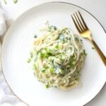 This Creamy Vegan Spinach Artichoke Pasta is like eating your favorite dip in pasta form. Ready in less than 30 minutes. The perfect weeknight dinner that is simple and comforting | ThisSavoryVegan.com #thissavoryvegan #vegan #spinachartichoke
