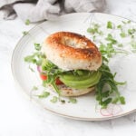 The Best Veggie Everything Bagel Sandwich - a toasted bagel is loaded up with vegan cream cheese, avocado and a whole lotta veggies. Perfect make ahead lunch | ThisSavoryVegan.com #thissavoryvegan #brunch #sandwich