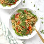 Raw veggies are tossed together with rice noodles and a tahini dressing in these Asian Tahini Noodle Bowls. A quick vegan dinner or make ahead lunch | ThisSavoryVegan.com #thissavoryvegan #mealprep