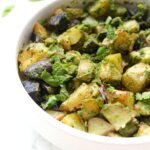 These Roasted Garlic and Pesto Potatoes are loaded with tons of fresh herbs - the perfect side dish for any time of year | ThisSavoryVegan.com #thissavoryvegan #potatoes #vegansidedish