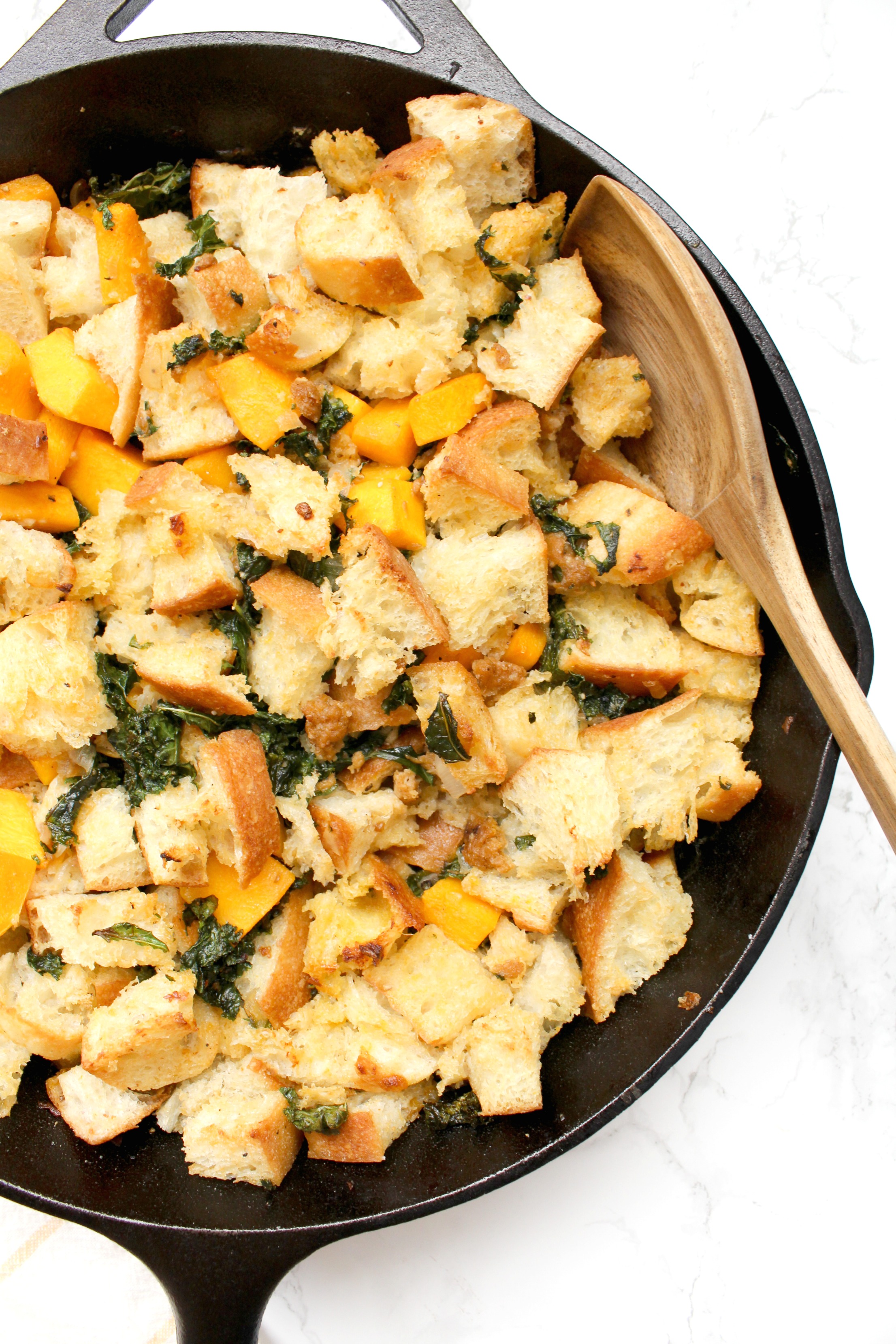 Make this Thanksgiving one to remember with this Vegan Sausage Kale Skillet Dressing. Filled with wilted kale, butternut squash and zesty vegan Italian sausage | ThisSavoryVegan.com #thissavoryvegan #veganthanksgiving #thanksgiving