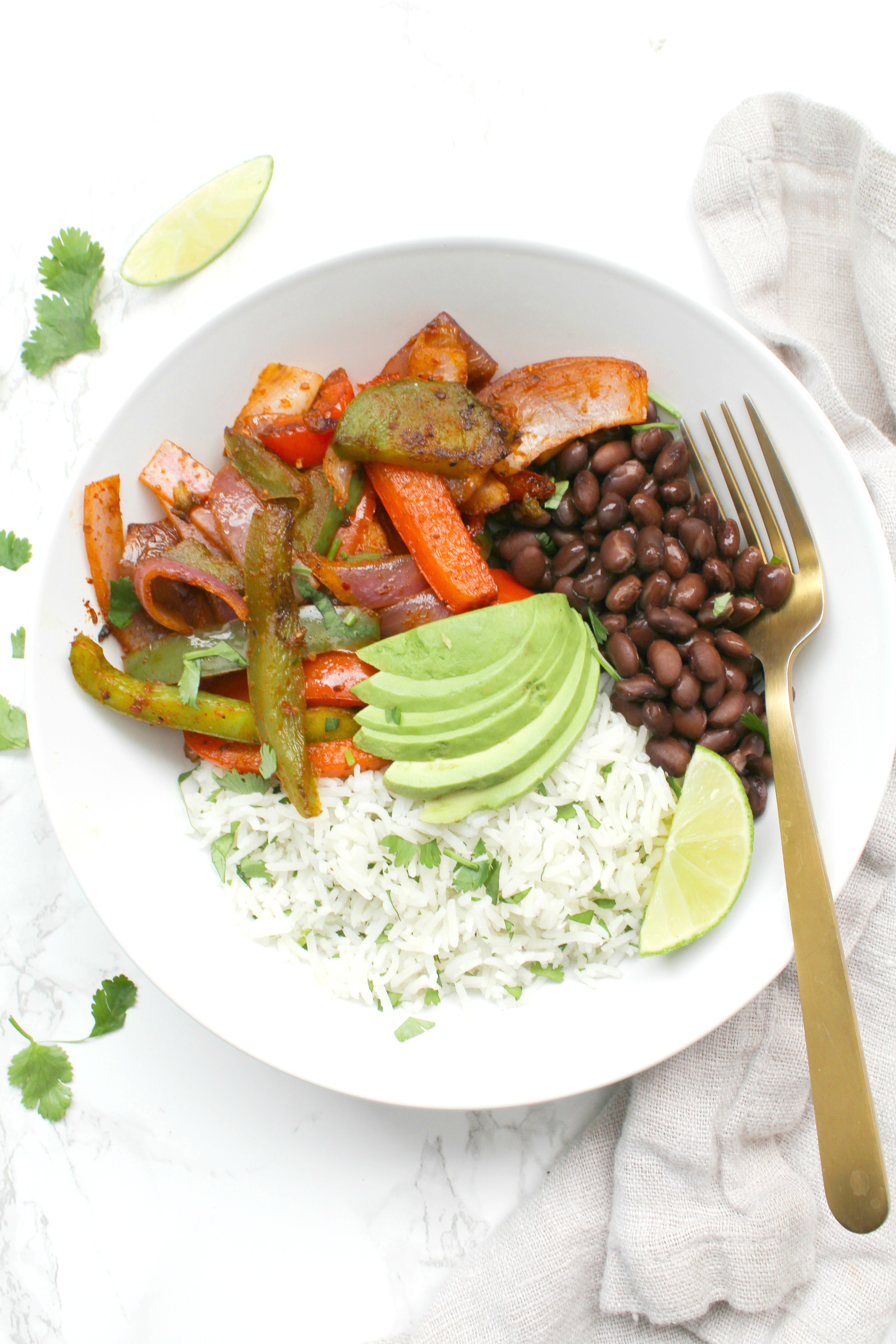 These Fajita Veggie Bowls with Cilantro Lime Rice are a tastier version of Chipotle that you can make at home in 30 minutes! | ThisSavoryVegan.com #thissavoryvegan #buddhabowl