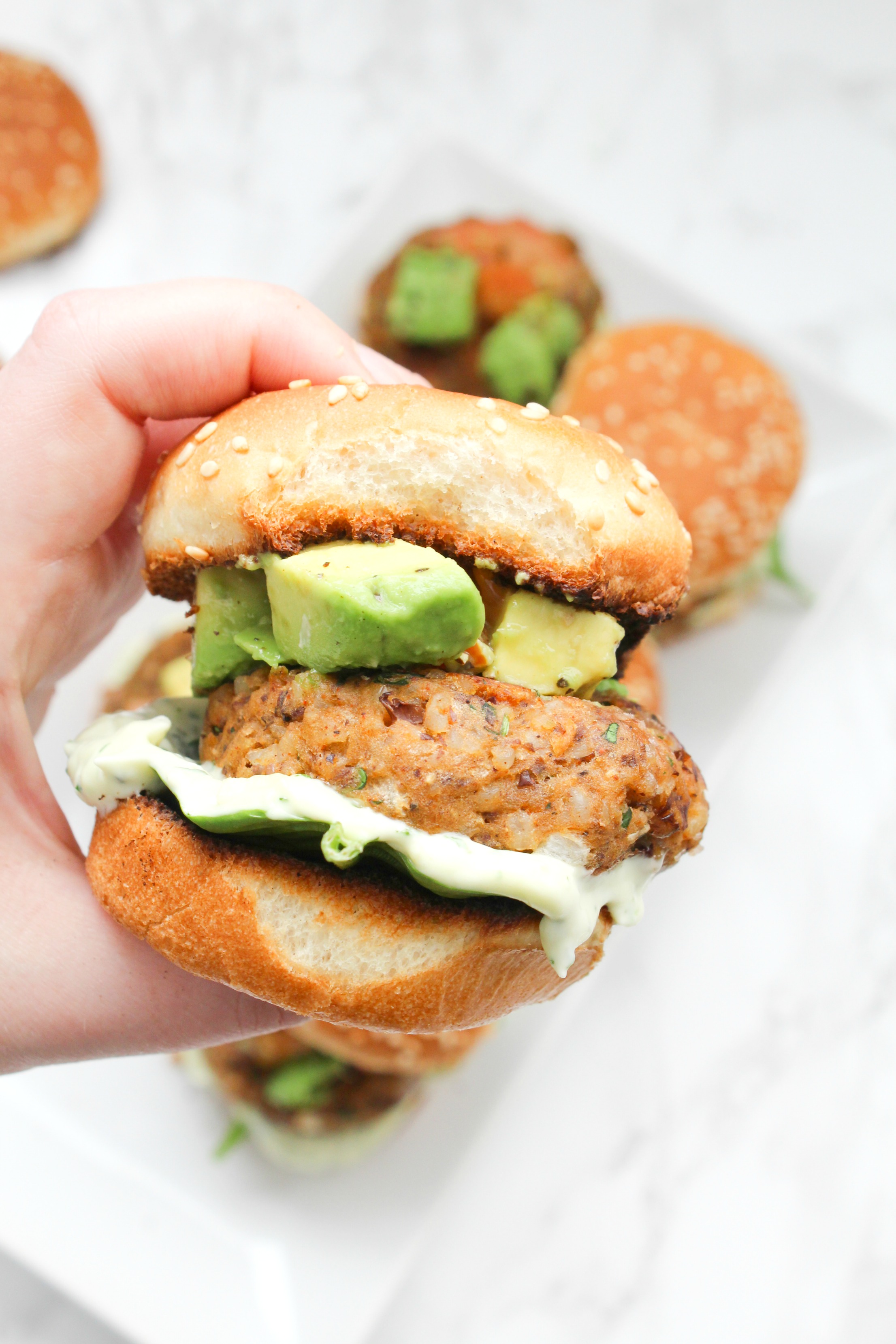 These Zesty Brown Rice Black Bean Vegan Sliders with Basil Aioli are the perfect party appetizer. Topped off with an avocado & tomato salsa | ThisSavoryVegan.com #thissavoryvegan #vegan #sliders