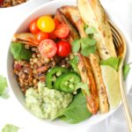These Chipotle Lentil Potato Bowls with Creamy Dreamy Green Sauce have everything you could want in one meal - roasted veggies, fresh veggies, warm lentils and the best green sauce | ThisSavoryVegan.com #thissavoryvegan #vegan #veganbowl