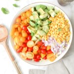 This Tomato Corn Avocado Pasta Salad is filled with fresh ingredients and topped with a light and zesty dressing. Perfect party side dish | ThisSavoryVegan.com #thissavoryvegan #vegan #partyfood