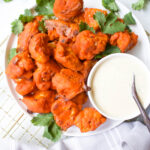 Flavored from the inside out and perfectly crispy, this really is The Best Baked Buffalo Cauliflower out there. Served with vegan ranch! | ThisSavoryVegan.com #thissavoryvegan #buffalocauliflower #vegan