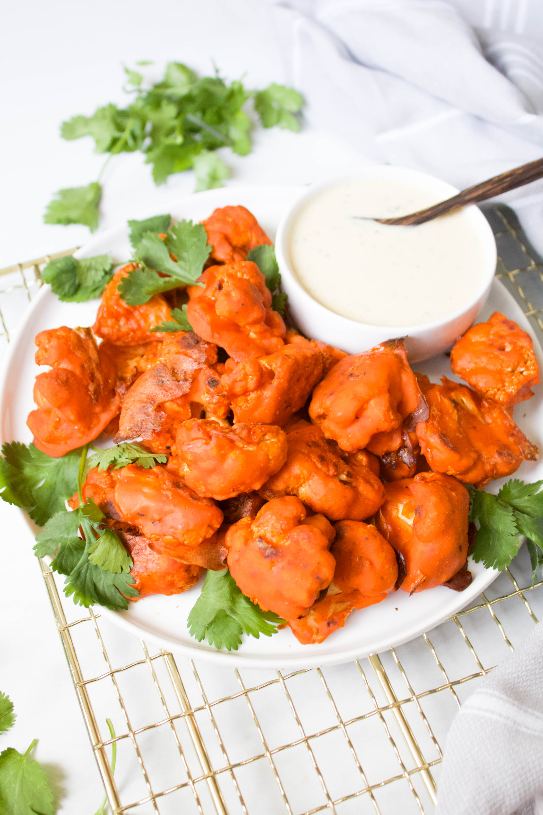 Flavored from the inside out and perfectly crispy, this really is The Best Baked Buffalo Cauliflower out there. Served with vegan ranch! | ThisSavoryVegan.com #thissavoryvegan #buffalocauliflower #vegan