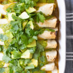 These Creamy Vegan Fajita Enchiladas are loaded with vegan cream cheese, bell peppers & onions, then topped with avocado, cilantro and green sauce | ThisSavoryVegan.com #thissavoryvegan #vegan #veganenchiladas
