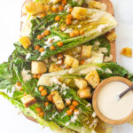 This Vegan Grilled Caesar Salad is the perfect summer salad - romaine is given a quick char then topped off with roasted chickpeas, homemade croutons and tahini caesar dressing | ThisSavoryVegan.com #thissavoryvegan #vegan #vegancaesarsalad