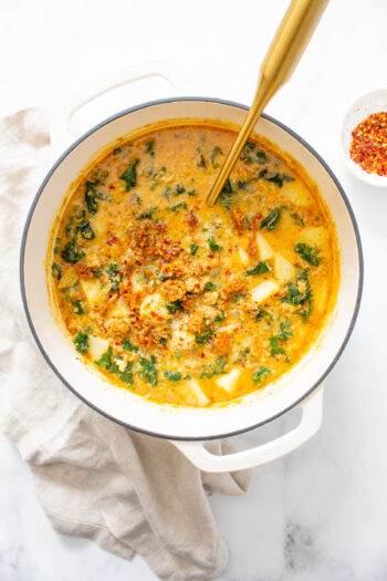 This Vegan Zuppa Toscana soup is perfectly creamy and comforting. Potatoes, vegan sausage and kale are loaded up in a super flavorful broth | ThisSavoryVegan.com #thissavoryvegan #vegansoup #zuppatoscana