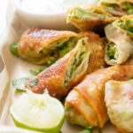 These Avocado Egg Rolls with Vegan Cilantro Ranch are the perfect party appetizer! Perfectly crispy, simple to make and totally tasty | ThisSavoryVegan.com #thissavoryvegan #vegan #eggrolls