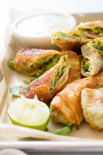 These Avocado Egg Rolls with Vegan Cilantro Ranch are the perfect party appetizer! Perfectly crispy, simple to make and totally tasty | ThisSavoryVegan.com #thissavoryvegan #vegan #eggrolls