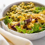 These Roasted Veggies with Creamy Vegan Spinach Orzo make up the ultimate bowl. Topped off with Mustard Tahini Dressing and fresh arugula! | ThisSavoryVegan.com #thissavoryvegan #veganbowls #spinachorzo