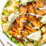 This Grilled Tempeh Vegan Caesar Salad is lightened up by using a tahini-based dressing and protein-packed with marinated tempeh | ThisSavoryVegan.com #thissavoryvegan #vegancaesar #salad