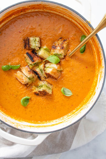 This Tomato Basil Soup with Vegan Grilled Cheese Croutons is made of a bunch of roasted veggies, basil pesto and the best croutons you've ever had | ThisSavoryVegan.com #thissavoryvegan #vegansoup #vegangrilledcheese