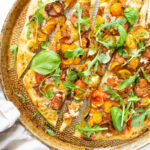This Vegan BLT Pizza is layered with a rosemary cream sauce, heirloom cherry tomatoes, tempeh bacon and arugula. A fun twist on a classic | ThisSavoryVegan.com #thissavoryvegan #veganpizza #blt