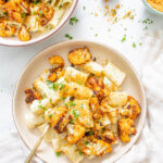 This Creamy Vegan Rigatoni with Roasted Cauliflower is made with a simple and delicious cream sauce, plenty of fresh herbs, and crispy roasted cauliflower. A tasty vegan dinner that is a crowd pleaser | ThisSavoryVegan.com #thissavoryvegan #veganpasta #vegandinner