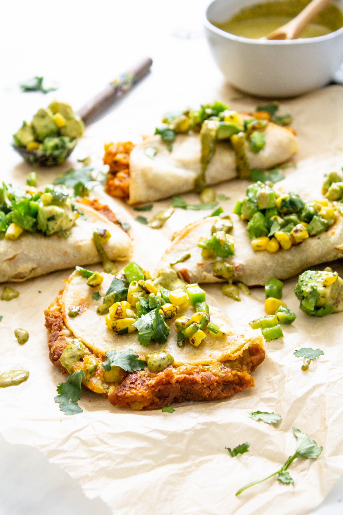 These Vegan Baked Tacos with Chipotle Ranch are the perfect weeknight dinner. Loaded with seasoned potatoes and beans then topped with avocado salsa and chipotle ranch | ThisSavoryVegan.com #thissavoryvegan #vegantacos #bakedtacos