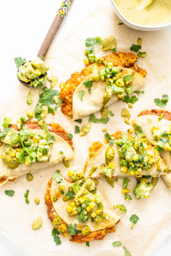 These Vegan Baked Tacos with Chipotle Ranch are the perfect weeknight dinner. Loaded with seasoned potatoes and beans then topped with avocado salsa and chipotle ranch | ThisSavoryVegan.com #thissavoryvegan #vegantacos #bakedtacos