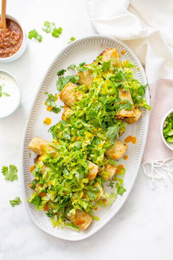 These Air Fryer Vegan Rolled Tacos are filled with beans and avocado before being layered with all of your favorite taco toppings. Simple and quick | ThisSavoryVegan.com #thissavoryvegan #airfryer #rolledtacos