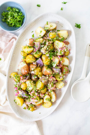 This No Mayo Vegan Potato Salad is packed with LOTS of herbs and an olive oil dressing that is tangy & delicious. The perfect summer side recipe | ThisSavoryVegan.com #thissavoryvegan #veganpotatosalad #summerrecipe