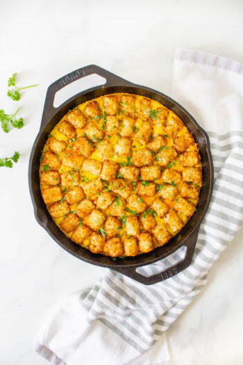 This Vegan Tater Tot Breakfast Casserole is loaded with vegan eggs, vegan sausage, tempeh bacon and veggies. The perfect vegan brunch or meal prep breakfast | ThisSavoryVegan.com #thissavoryvegan #veganbrunch #vegancasserole