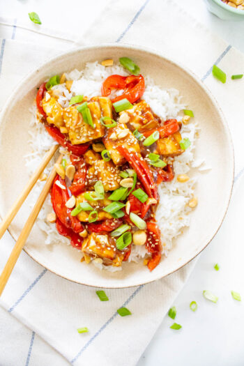 These Vegan Kung Pao Tofu Bowls are a better than takeout vegan dinner at home. Filled with sticky, savory & sweet tofu, red bell pepper & rice | ThisSavoryVegan.com #thissavoryvegan #kungpao #tofurecipes