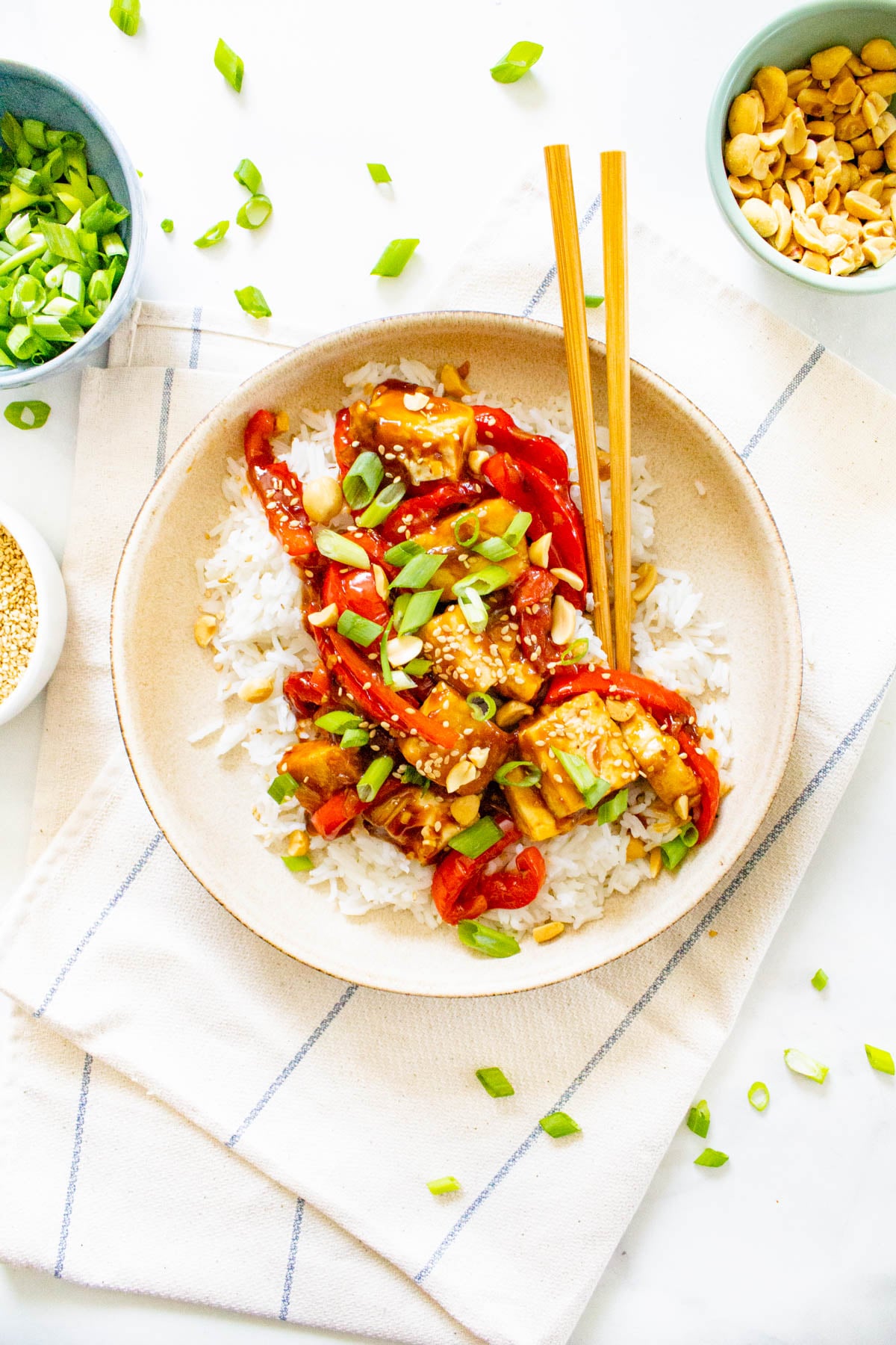 These Vegan Kung Pao Tofu Bowls are a better than takeout vegan dinner at home. Filled with sticky, savory & sweet tofu, red bell pepper & rice | ThisSavoryVegan.com #thissavoryvegan #kungpao #tofurecipes