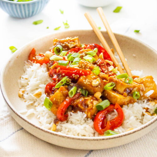 These Vegan Kung Pao Tofu Bowls are a better than takeout vegan dinner at home. Filled with sticky, savory & sweet tofu, red bell pepper & rice | ThisSavoryVegan.com #thissavoryvegan #kungpao #tofurecipes
