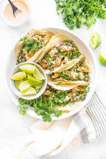 These Vegan Lemon Pepper Chicken Tacos are loaded with a kale avocado slaw and a chili lime crema. Perfect for your next Taco Tuesday | ThisSavoryVegan.com #thissavoryvegan #vegantacos #lemonpepperchicken