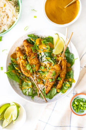 These Vegan Chicken Satay Bowls are loaded with coconut rice, spinach, air fryer vegan chicken satay skewers and a curry peanut sauce! Comforting and quick dinner idea | ThisSavoryVegan.com #thissavoryvegan #veganchickensatay #peanutsauce