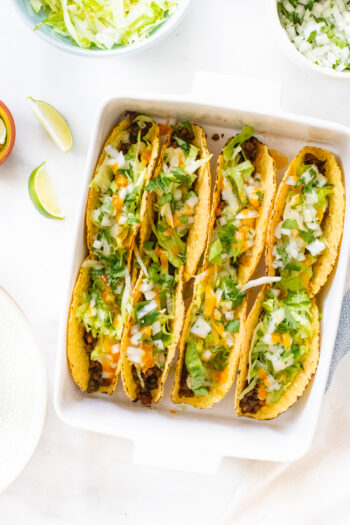 These Vegan Oven Baked Tacos are the perfect weeknight dinner. Crispy taco shells are loaded with lentil taco "meat" and vegan queso | ThisSavoryVegan.com #thissavoryvegan #vegantacos #tacocasserole