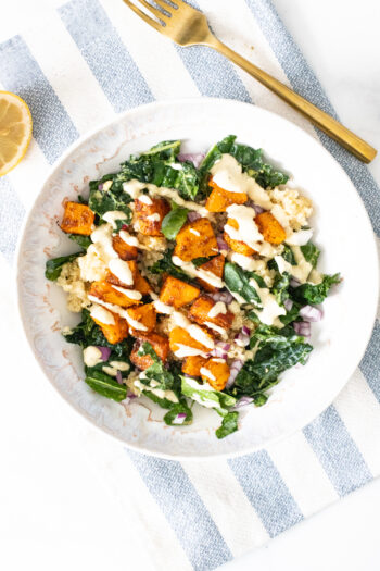 These Butternut Squash Quinoa Bowls are a hearty, healthy and tasty meal. Filled with roasted veggies, marinated kale and a mustard tahini dressing | ThisSavoryVegan.com #thissavoryvegan #veganbowls #quinoarecipes