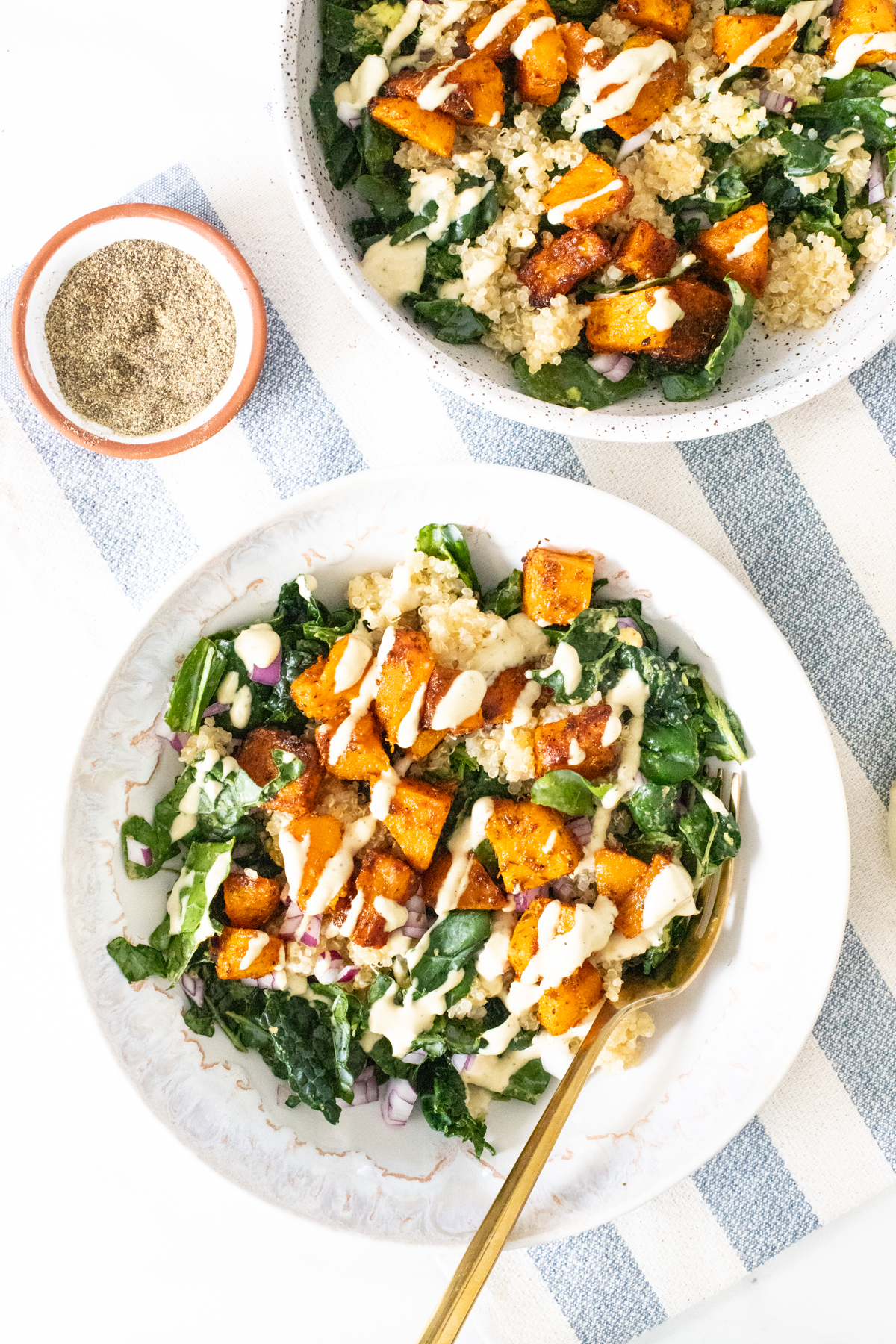 These Butternut Squash Quinoa Bowls are a hearty, healthy and tasty meal. Filled with roasted veggies, marinated kale and a mustard tahini dressing | ThisSavoryVegan.com #thissavoryvegan #veganbowls #quinoarecipes