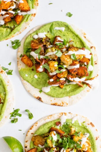 These Vegan Butternut Squash Tacos with Crispy Brussels Sprouts are loaded with flavor - from the avocado spread to the lime crema. Perfect Fall tacos! | ThisSavoryVegan.com #thissavoryvegan #vegantacos #butternutsquash