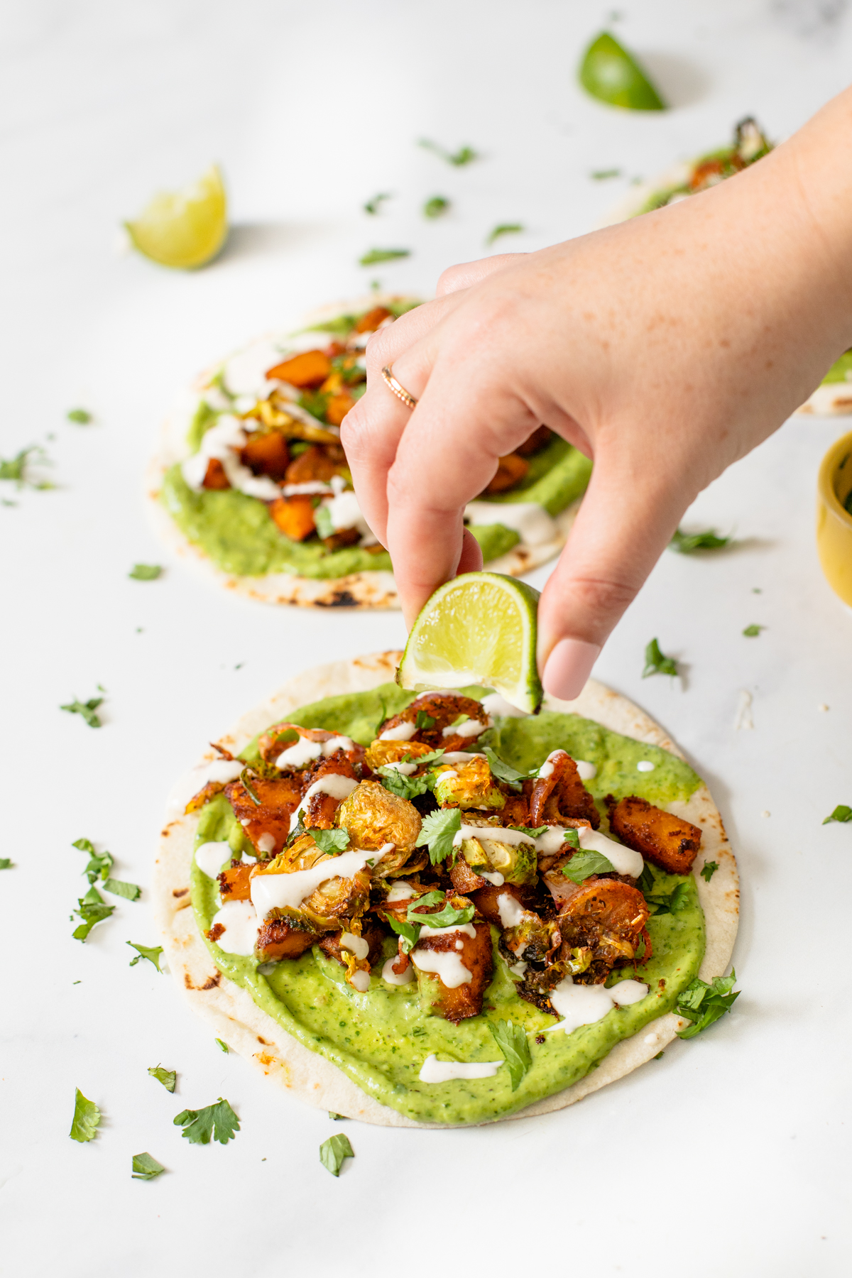 These Vegan Butternut Squash Tacos with Crispy Brussels Sprouts are loaded with flavor - from the avocado spread to the lime crema. Perfect Fall tacos! | ThisSavoryVegan.com #thissavoryvegan #vegantacos #butternutsquash