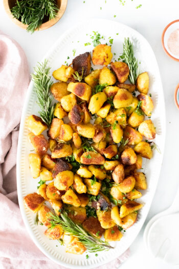 These Crispy Roasted Herb Potatoes are the ultimate vegan potato recipe! Loaded with garlic, rosemary and infused oil | ThisSavoryVegan.com #thissavoryvegan #crispypotatoes #herbpotatoes