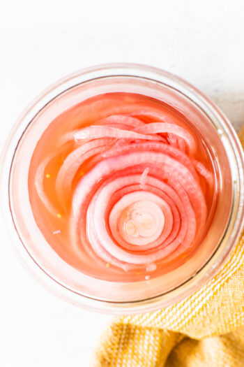 These Quick Pickled Onions are made with simple ingredients and ready in 30 minutes. The perfect topping for burgers, tacos and salads | ThisSavoryVegan.com #thissavoryvegan #pickledonions #easypickledonions
